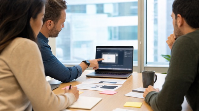 Team reviewing a software feature release tutorial video